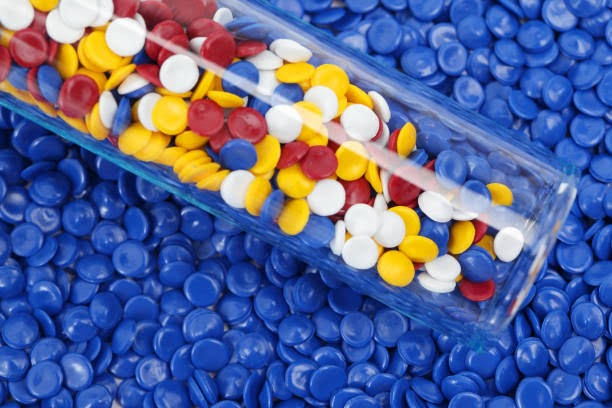 Colorful PVC polymer pellets in a lab test tube for stabilizer testing